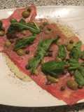 Carpaccio con aceitunas y rúcula