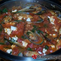 A picture of Mussels saganaki in tomato sauce.