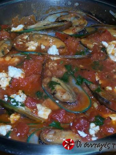 A picture of Mussels saganaki in tomato sauce.