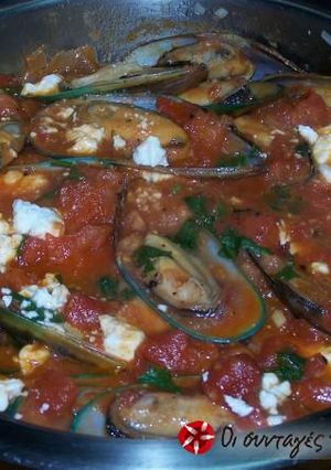 A picture of Mussels saganaki in tomato sauce.