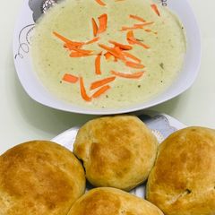 A picture of Dinner rolls served with potato and leek soup.