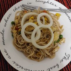 A picture of Noodles with some veggies and egg.