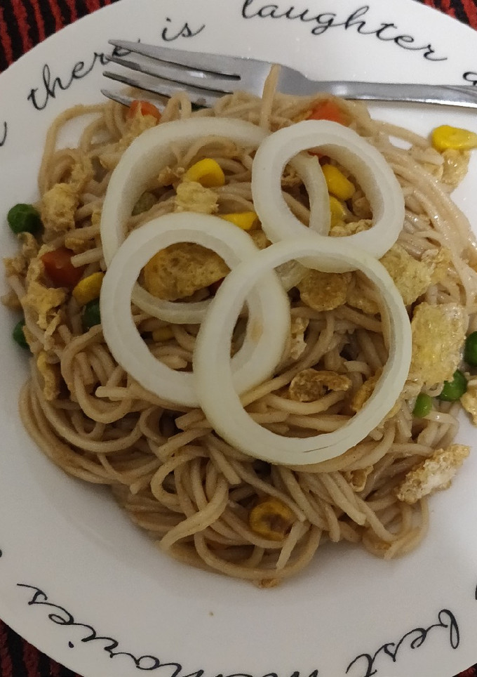 A picture of Noodles with some veggies and egg.