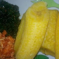 A picture of Plantain with egg sauce n vegetables.