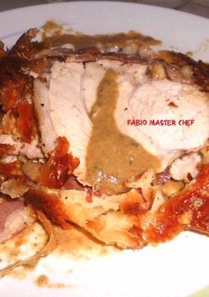 A picture of Puff Pastry with Pork Loin Wrapped in Bacon on Porcini Mushroom Cream.