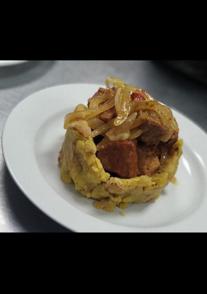 Una foto de Mofongo con Carne Frita bañada en un Escabeche
