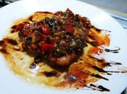 Una foto de muslos de pollo en salsa horno