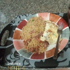 A picture of Sausage Noodles with fried egg.