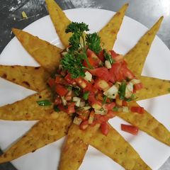 A picture of Nachos with salsa sauce Homemade.