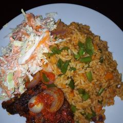 Jollof Rice/peppered Goat meat /Cole slaw A picture of Jollof Rice/peppered Goat meat /Cole slaw.