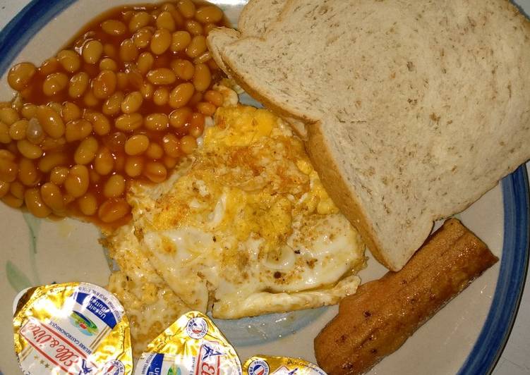 Oyibo breakfast (fried egg,bread, baked beans, sausage)