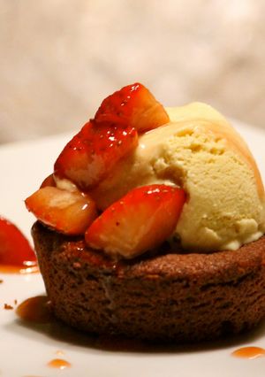 A picture of Double Chocolate cake with Ice Cream and Caramelized Strawberries.