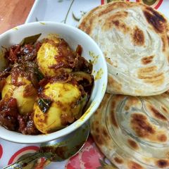 A picture of Kerela Egg Roast/Nadan Mutta Roast and Malabar Paratha.