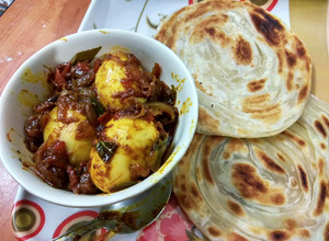 A picture of Kerela Egg Roast/Nadan Mutta Roast and Malabar Paratha.