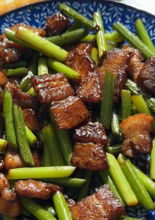 A picture of Stir-Fried Garlic Scapes with Pork Belly.