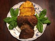 A picture of pork steak on the grill