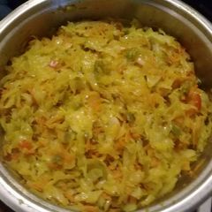 A picture of Fried cabbage with carrots and peppers.