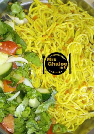 A picture of Jallof sphagetti with salad.