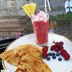 A picture of Pineapple, blueberry, grapes, strawberry, and raspberry juice...