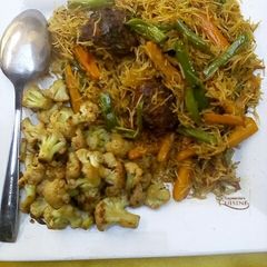 A picture of Stir fry vegetables vermicelli pasta with meat balls.