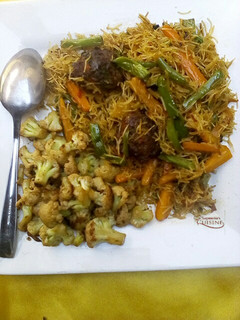 A picture of Stir fry vegetables vermicelli pasta with meat balls.