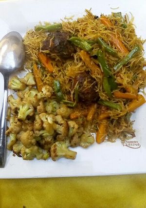A picture of Stir fry vegetables vermicelli pasta with meat balls.