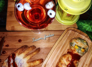 A picture of Mummy kabab wrapped, hand garlic toast and eyeball punch.