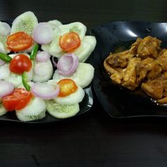 A picture of Tandoori chicken with salad.