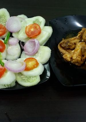 A picture of Tandoori chicken with salad.