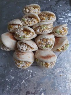 A picture of Stuffed Batbout with Chicken and White Sauce.