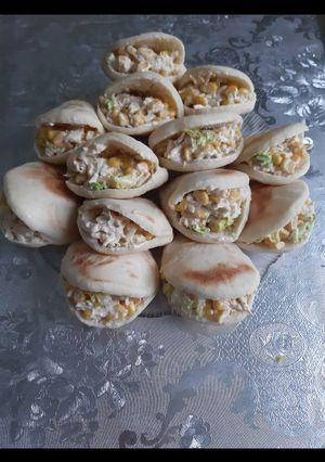 A picture of Stuffed Batbout with Chicken and White Sauce.