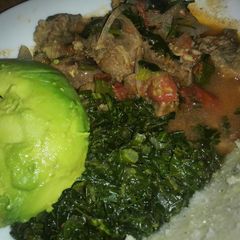 Beef stew served with ugali and saute kale A picture of Beef stew served with ugali and saute kale.
