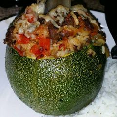 A picture of Round, Stuffed Zucchini with Brown Rice, Ground Beef, Red Pepper.