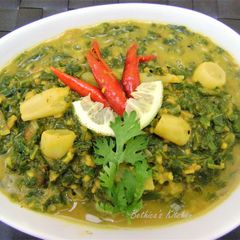 A picture of Mulo Shaag Diye Bhaja Muger Dal (Radish Leaves Cooked With Lentils).
