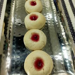 A picture of Thumb Print Jam Cookies with White Butter.