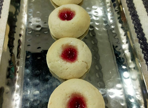 A picture of Thumb Print Jam Cookies with White Butter.