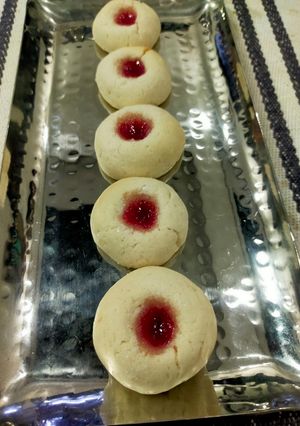 A picture of Thumb Print Jam Cookies with White Butter.