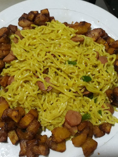 A picture of Noddles with fried plantain.