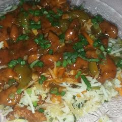 A picture of Fried rice with Manchurian gravy and noodles.