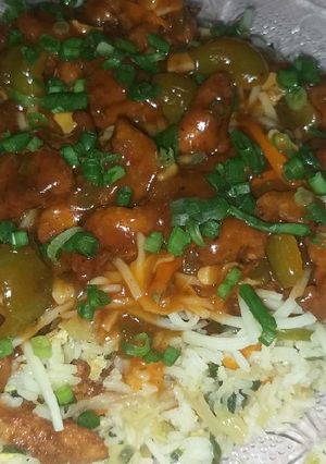 A picture of Fried rice with Manchurian gravy and noodles.