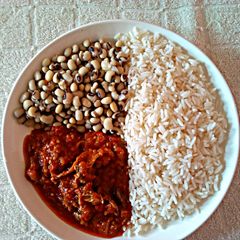 A picture of Rice and Beans with Stew.