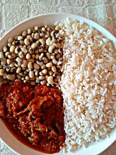 A picture of Rice and Beans with Stew.