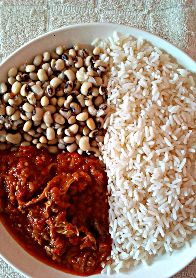 A picture of Rice and Beans with Stew.
