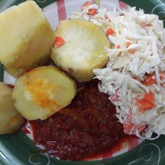 A picture of Sweet potatoes with coleslaw and tomato sauce.