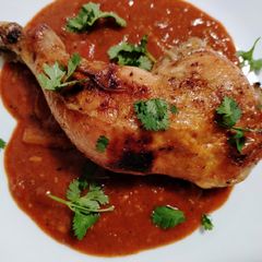 A picture of Slow-roasted chicken and enchilada pan sauce.
