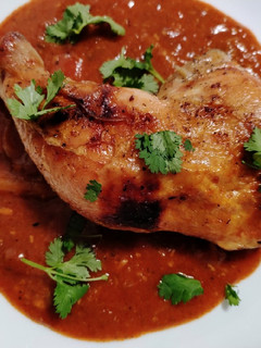 A picture of Slow-roasted chicken and enchilada pan sauce.