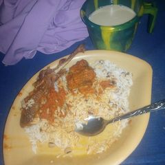 A picture of Rice and stew with my cold kunu.