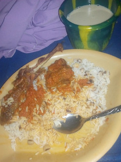 A picture of Rice and stew with my cold kunu.