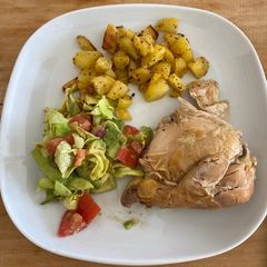 A picture of Roasted chicken with potatoes and salad.