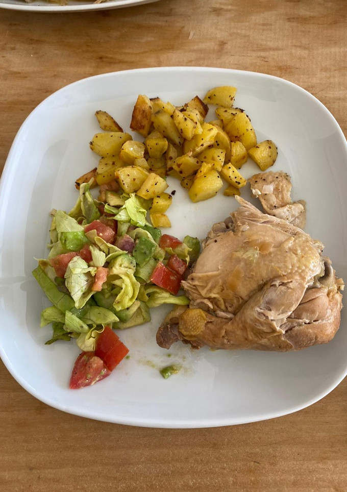 A picture of Roasted chicken with potatoes and salad.